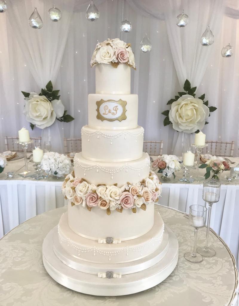 A wedding cake with the initials e and g on it