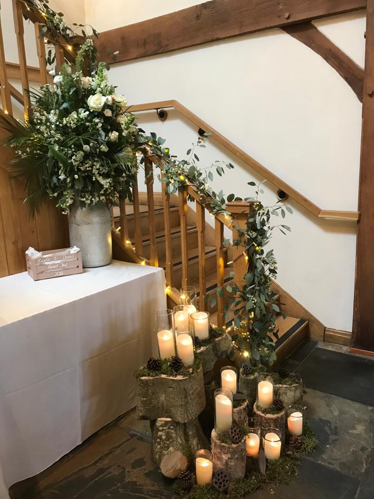A staircase decorated with candles and flowers