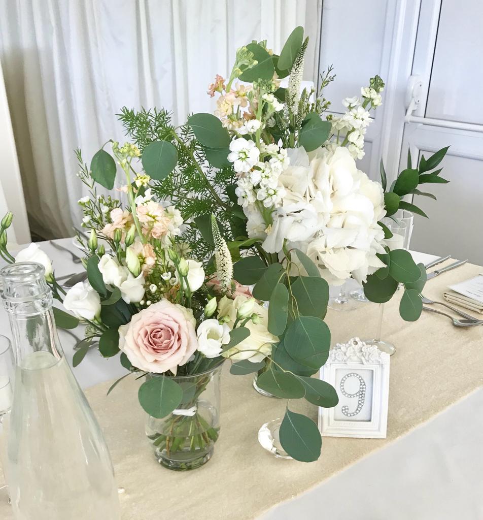 A table with a vase of flowers and a table number 9