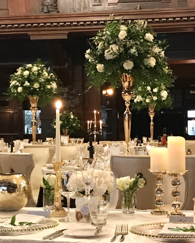 A table setting with candles and flowers on it