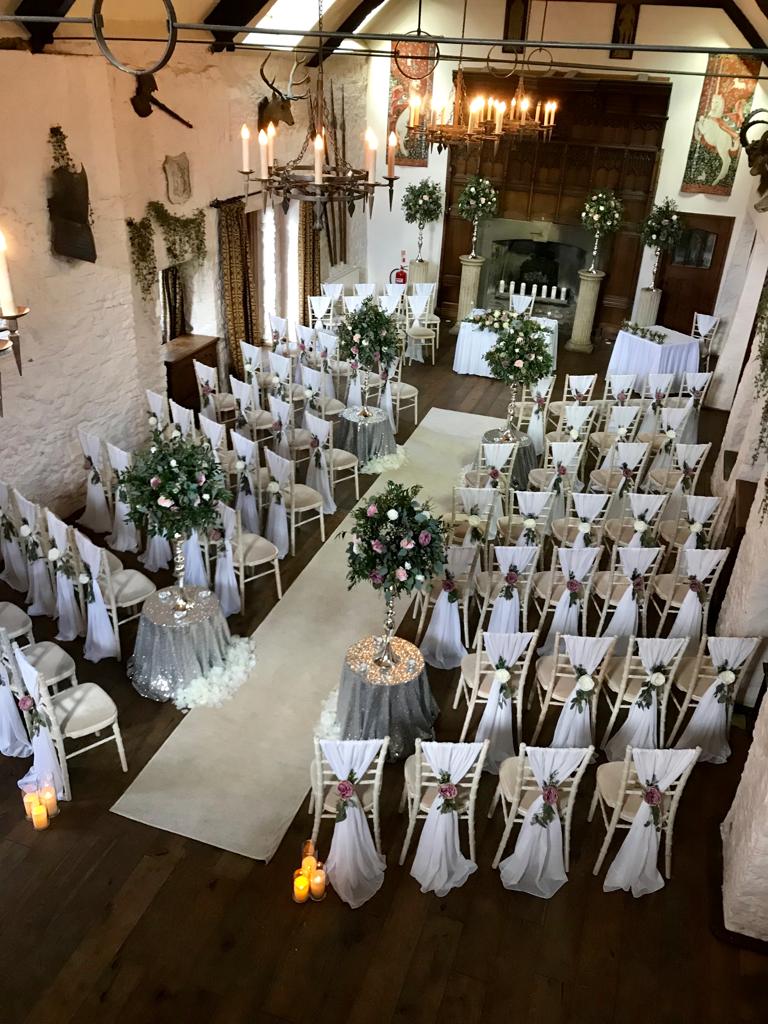 A wedding ceremony is being held in a large room