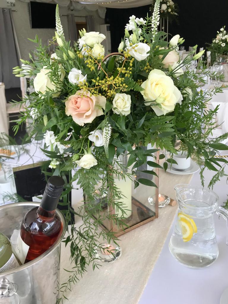 A table with flowers and a pitcher of water
