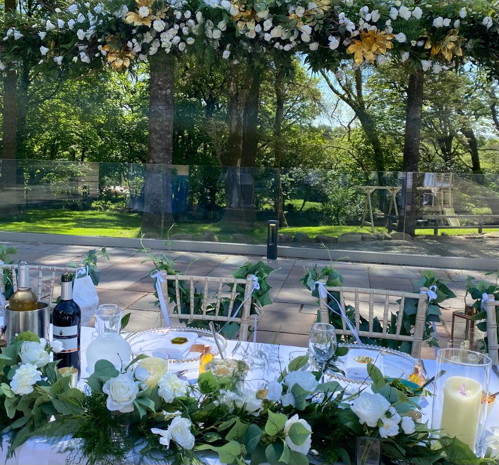 a table with flowers and a bottle of wine