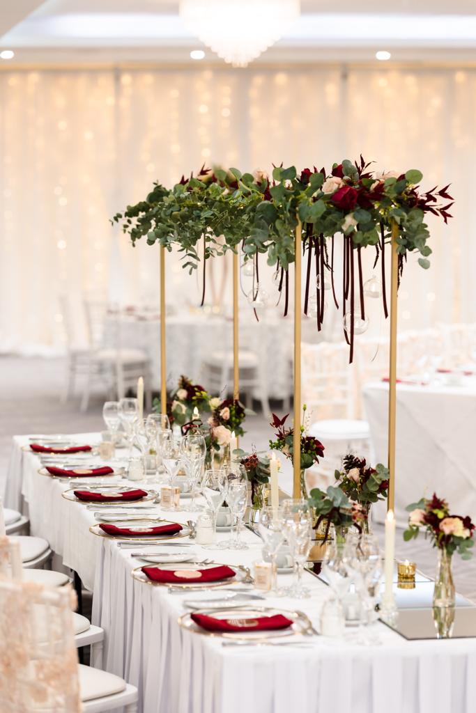 a long table set for a wedding reception with flowers and candles