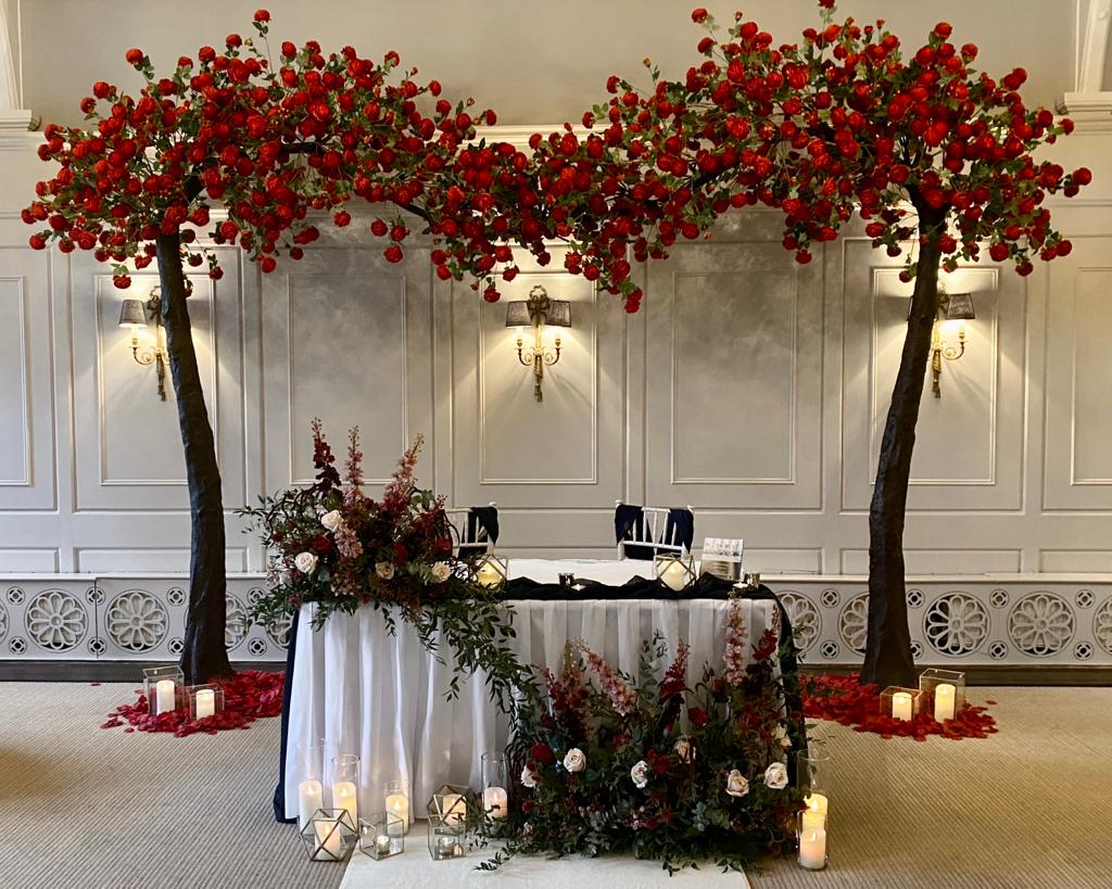 a table with flowers and candles on it in a room