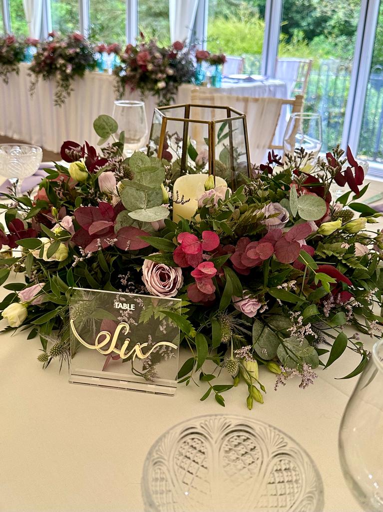 a table with flowers and the number six on it