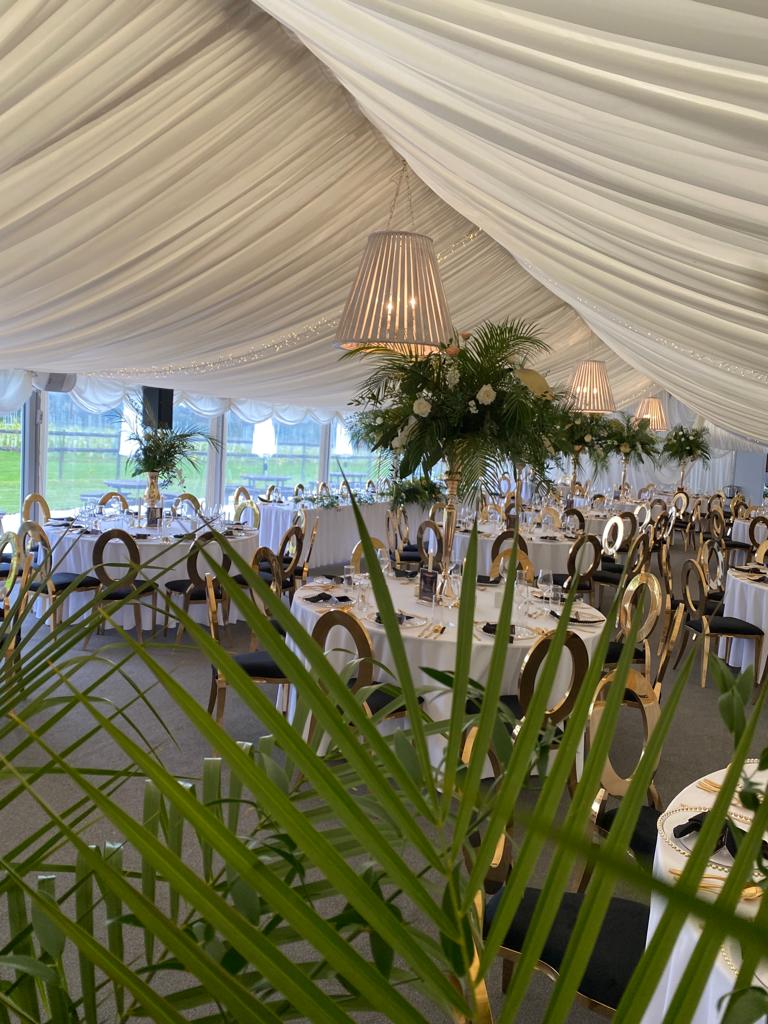 a large tent with tables and chairs set up for a wedding