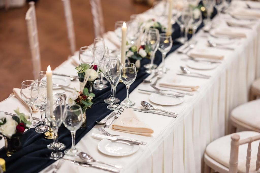 a long table set for a wedding with wine glasses and candles