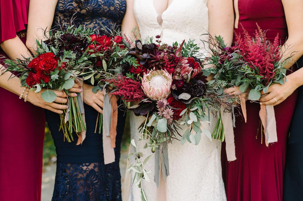the bride and her bridesmaids are holding their bouquets of flowers