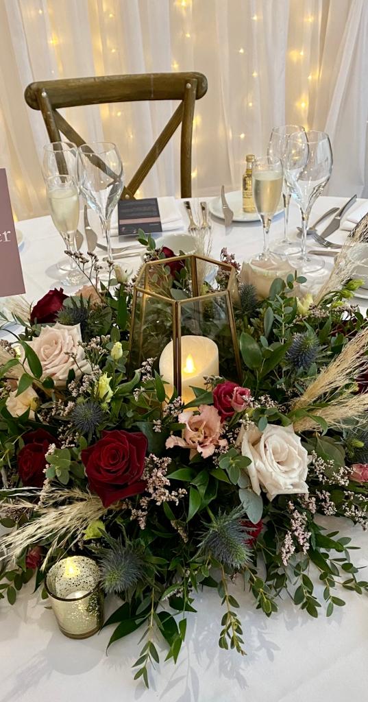 a table with flowers and candles on it